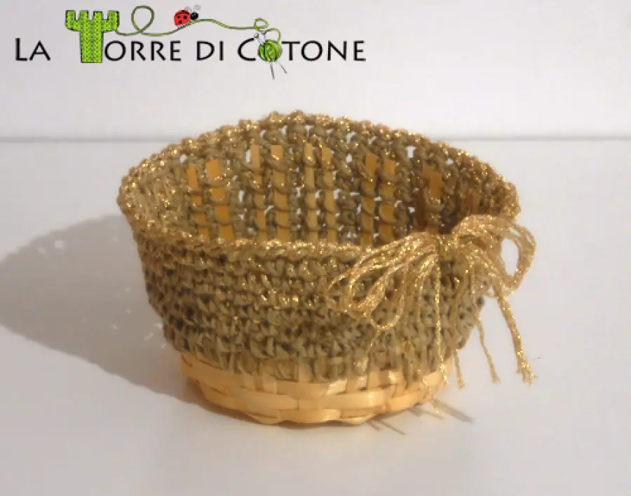 Un cestino all'uncinetto riciclando un contenitore in vimini